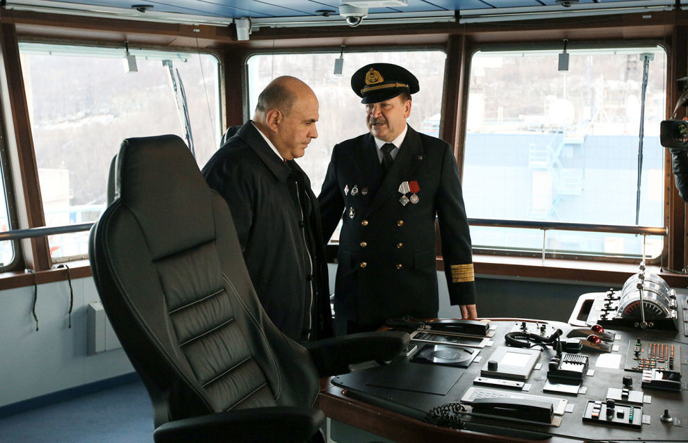 Russian Prime Minister Mikhail Mishustin, left, and Arktika ship's captain Alexander Spirin examine the Akrtika nuclear icebreaker during its launching in the northern city of Murmansk, Russia