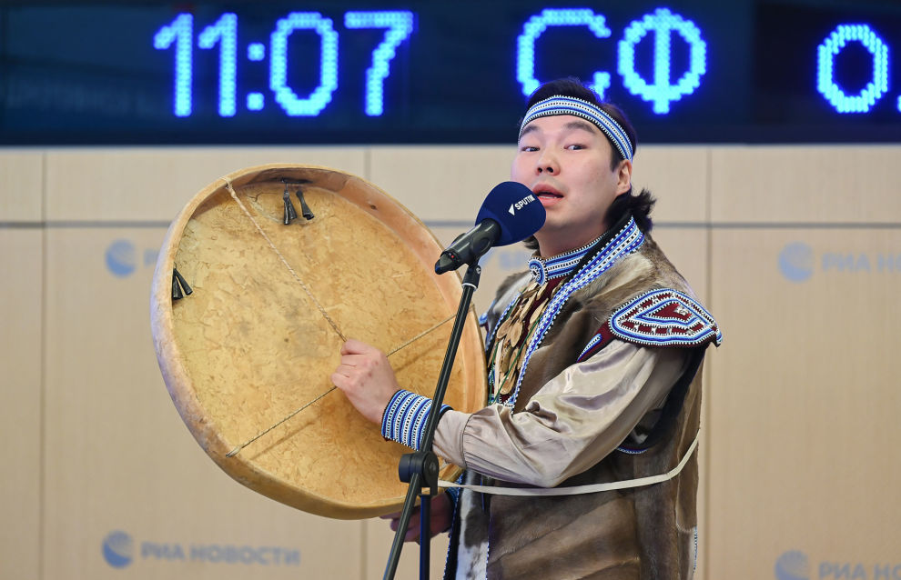 A musician performs at the news conference on holding the science and practical conference on climate change and permafrost melting