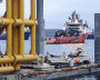 A tugboat tows the LNG production platform from the dry dock at the Novatek‒Murmansk LNG Construction Center