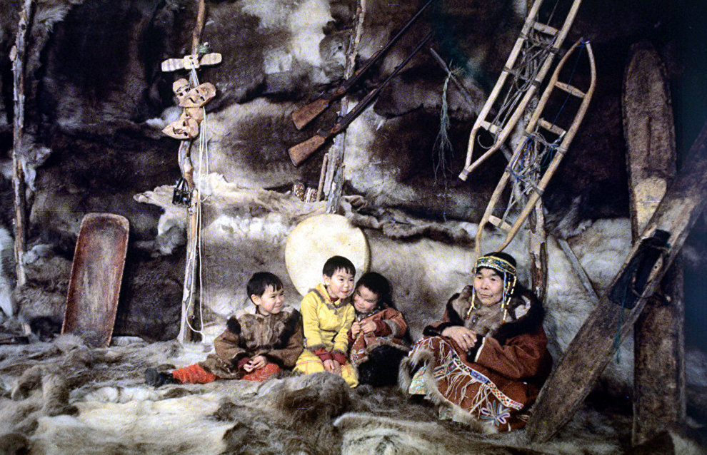 A Koryak family inside a traditional Yaranga wigwam