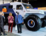 Forum participants near the Trecol-Husky snow and swamp-going vehicle displayed at the 9th International Forum The Arctic: Today and the Future, in St. Petersburg