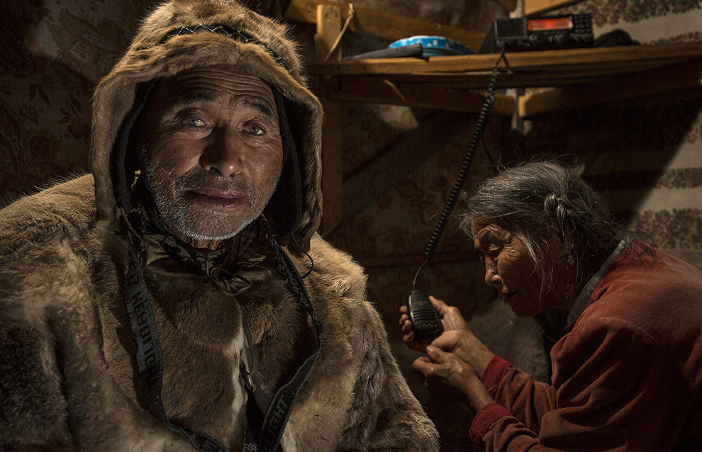 Dolgan reindeer herders communicate with their nomad neighbors via a shortwave radio. The valley of the Popigai River, Taimyr