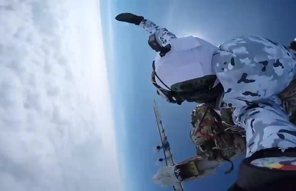 Russian paratroopers perform a group jump from an Ilyushin Il-76 aircraft from 10,000 m of altitude, using parachute systems in the extreme Arctic conditions near the Franz Josef Land Archipelago