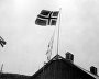 The national flag of Norway hoisted on a house roof in liberated Kirkenes